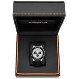 A Cornavin men's watch with a black rubber strap and silver-toned case, displayed inside its open black textured presentation box with orange stitching.