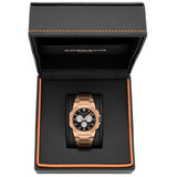 A Cornavin men's watch with a rose gold-tone case and a black dial, presented inside its black textured gift box with orange stitching.