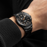 Wrist of man with a black watch